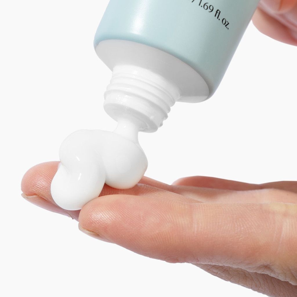 thick white cream coming out of tube of biome boost cream collagen moisturizer